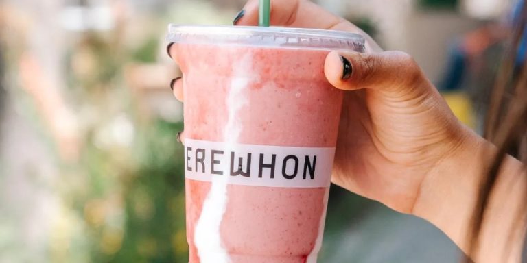 Homemade Hailey Bieber Strawberry Glaze Smoothie with avocado, almond milk, and collagen peptides, served in a clear glass.