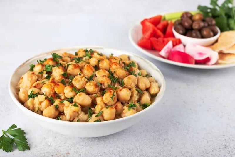 Warm Arabic balila chickpea breakfast dish with olive oil, cumin, and parsley