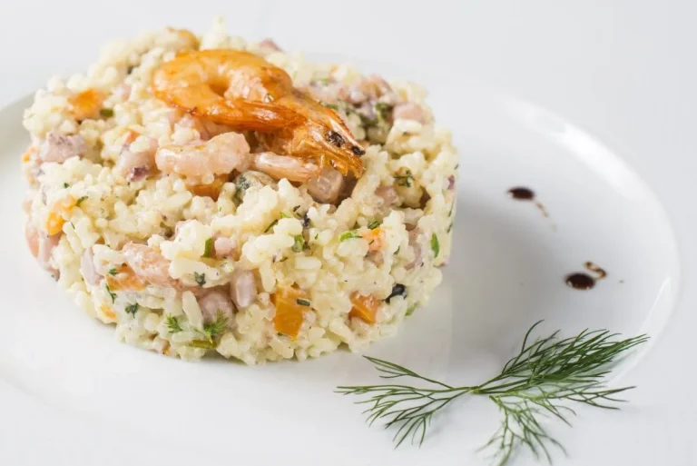 Close-up of a vibrant rice salad with avocado, tomatoes, and grilled chicken pieces