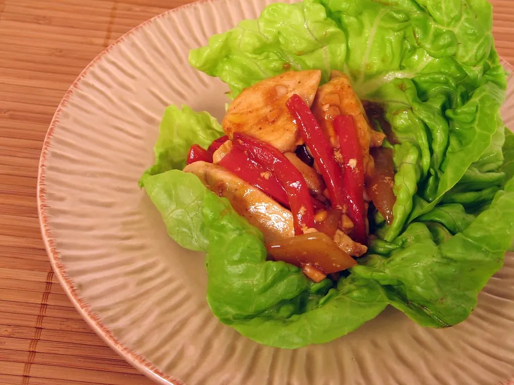 Korean-inspired lettuce wraps filled with gochujang sauce, vegetables, and protein for a healthy dinner
