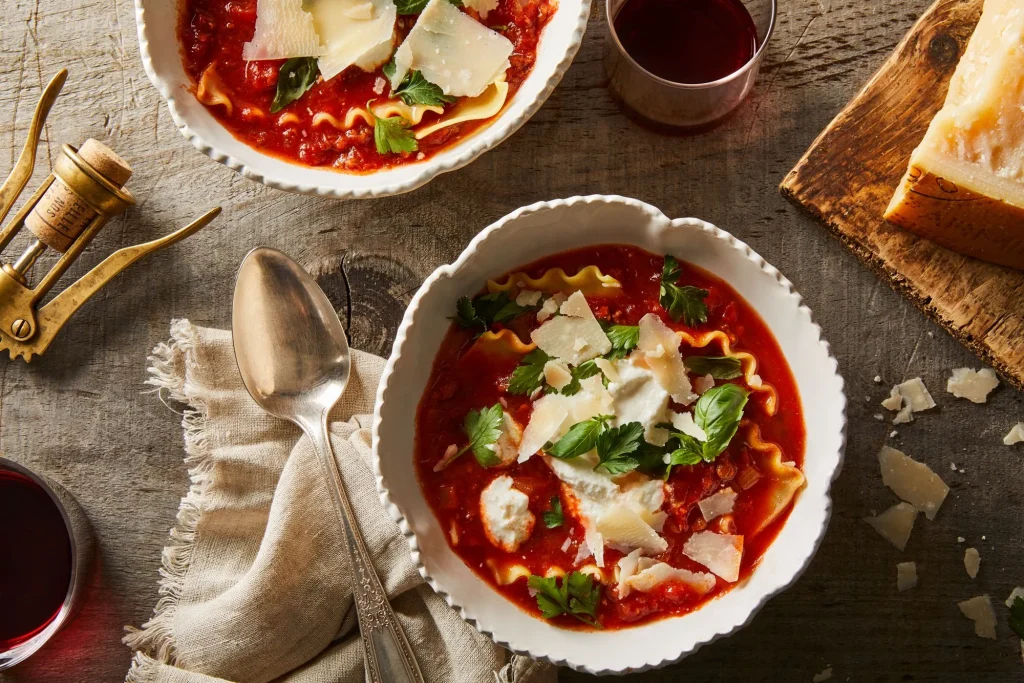 Creamy lasagna soup served in a bowl with melted mozzarella and fresh basil, perfect one-pot dinner