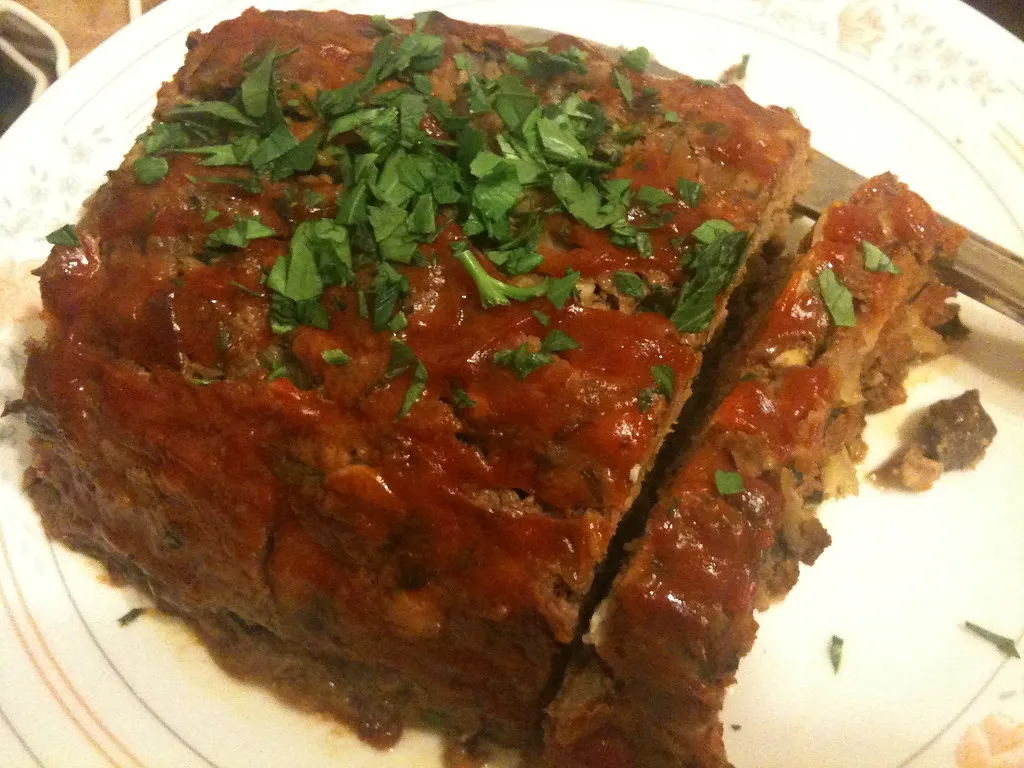 Homemade meatloaf made with Lipton onion soup mix, topped with ketchup glaze and served with mashed potatoes.