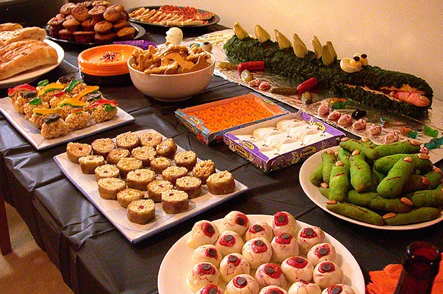 Close-up of spider deviled eggs and mummy hot dogs served as fun Halloween finger foods.
