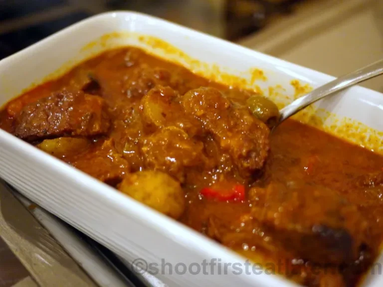 Tender beef Caldereta in tomato sauce with potatoes, carrots, and bell peppers — a traditional Filipino stew.