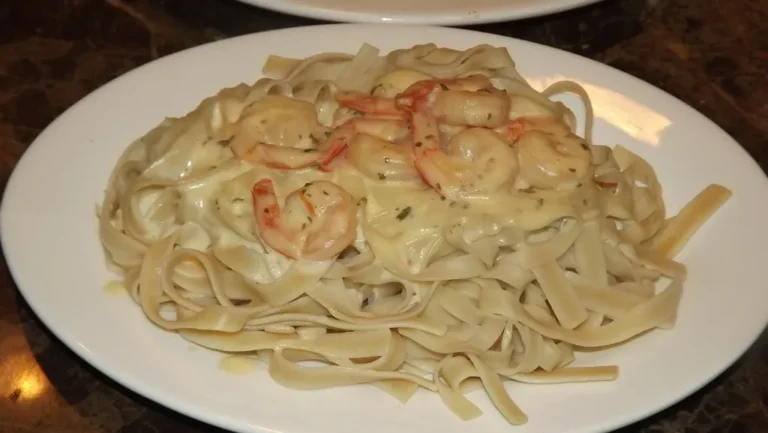 Spicy Cajun Alfredo pasta served in a bowl with chicken, shrimp, and a creamy cheesy sauce.
