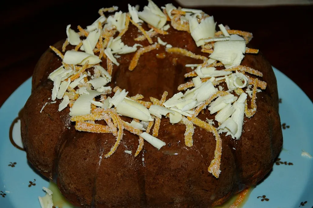 Homemade carrot bundt cake with cream cheese glaze on a white plate