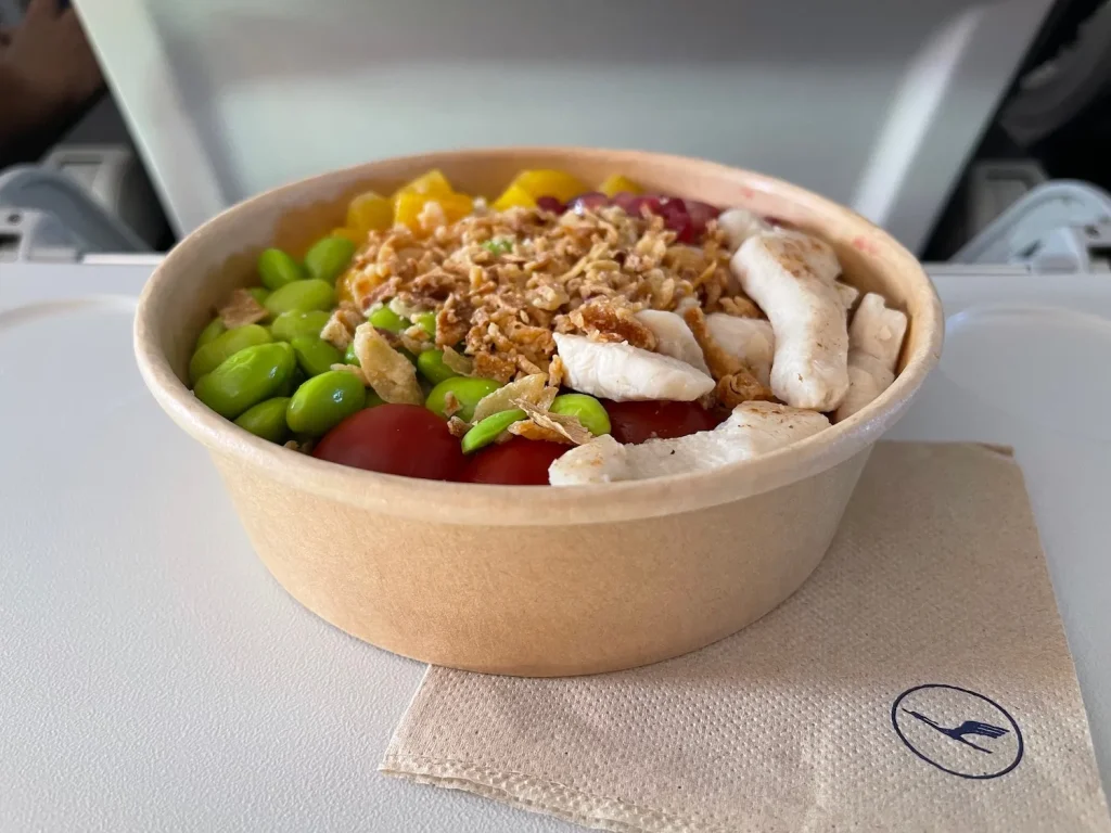 Close-up of a healthy ground turkey and rice bowl with vegetables and fresh herbs.