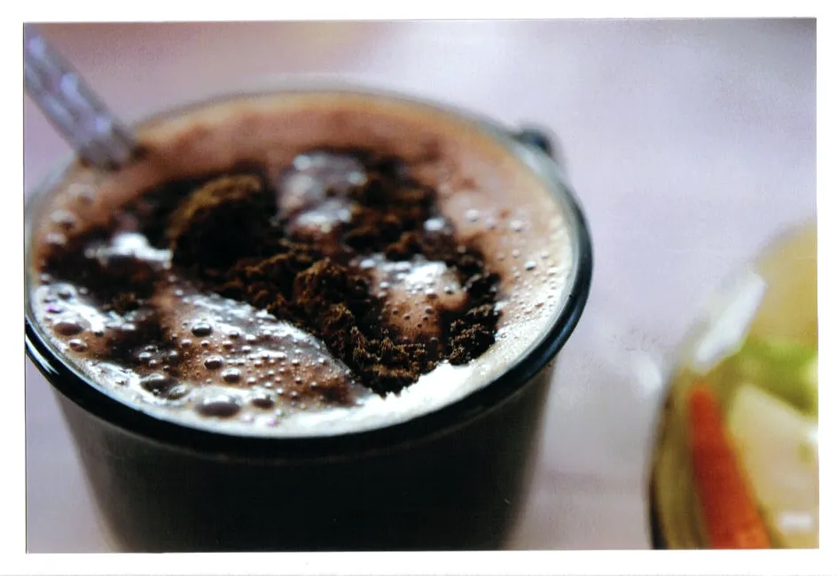 Warm and gooey Oreo mug cake served in a white cup topped with whipped cream and crushed Oreo cookies