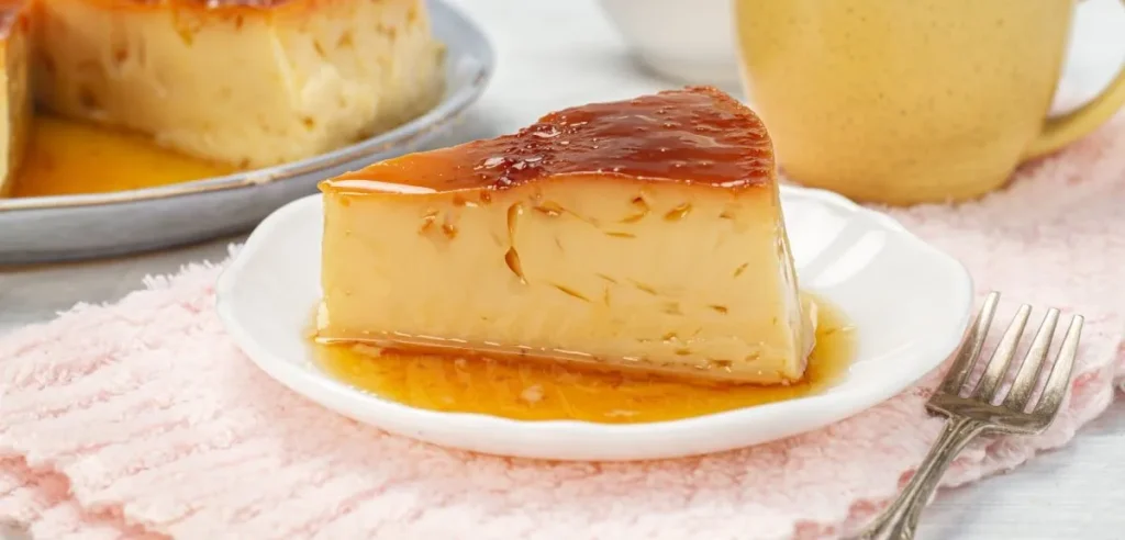 Venezuelan quesillo flan with golden caramel topping, served on a white plate