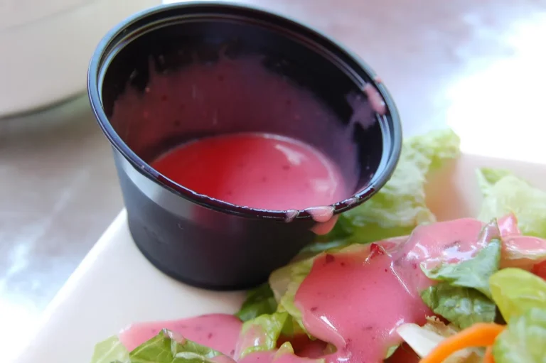 Sweet and tangy Catalina dressing poured over a fresh leafy green salad.
