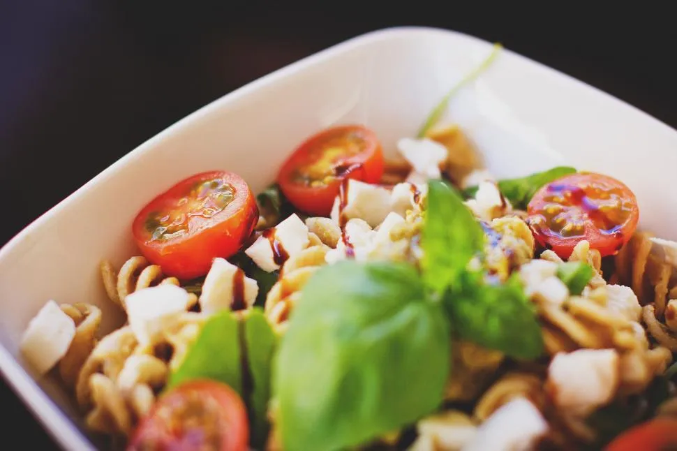 Close-up of sautéed grape tomatoes and garlic in olive oil for pasta sauce