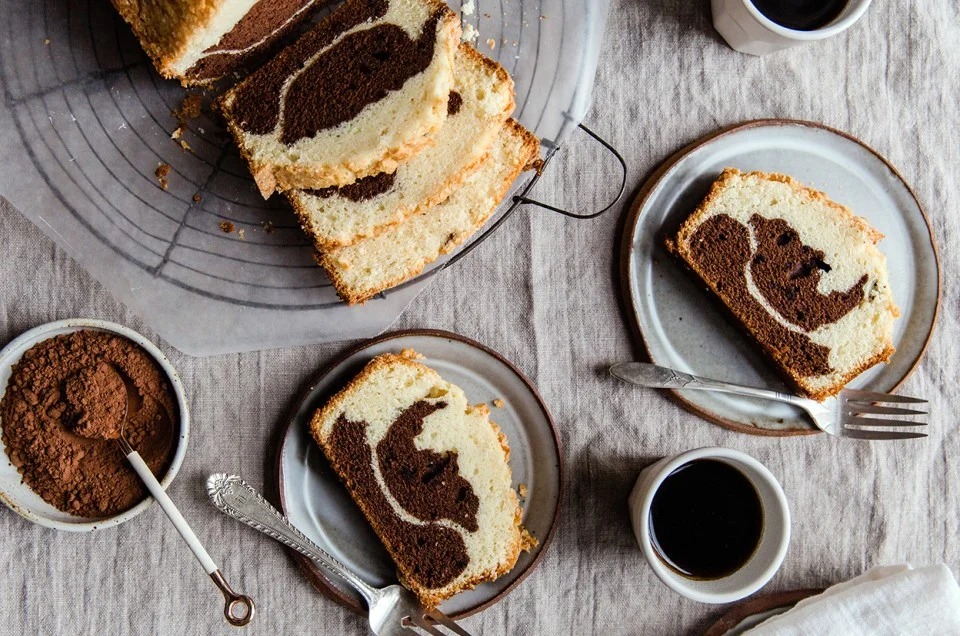 A fluffy and moist protein powder cake sliced on a wooden board, showing its soft, tender texture