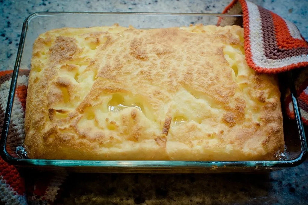 Golden-baked Amish breakfast casserole with sausage, cheese, and crispy hash browns in a farmhouse kitchen
