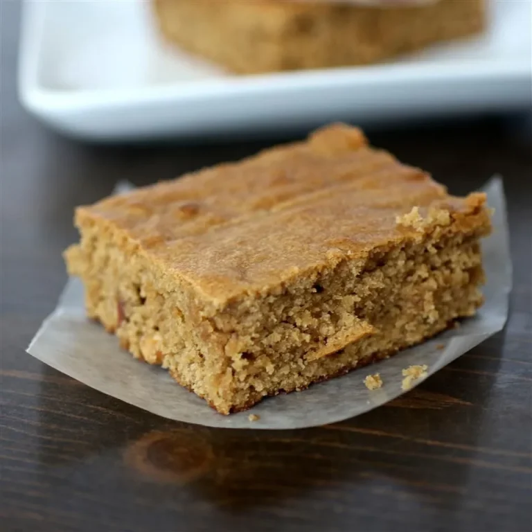Freshly baked peanut butter blondies cut into squares, served with a drizzle of caramel