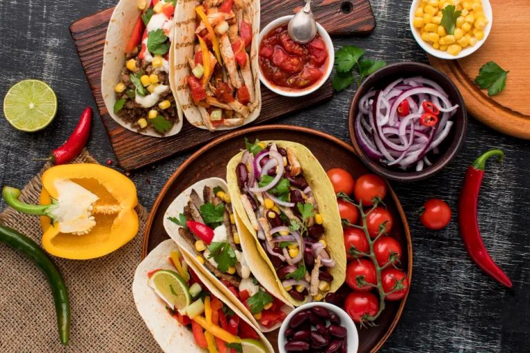 Easy Mexican family dinner spread including tacos, fajitas, bowls, and enchiladas on a colorful table