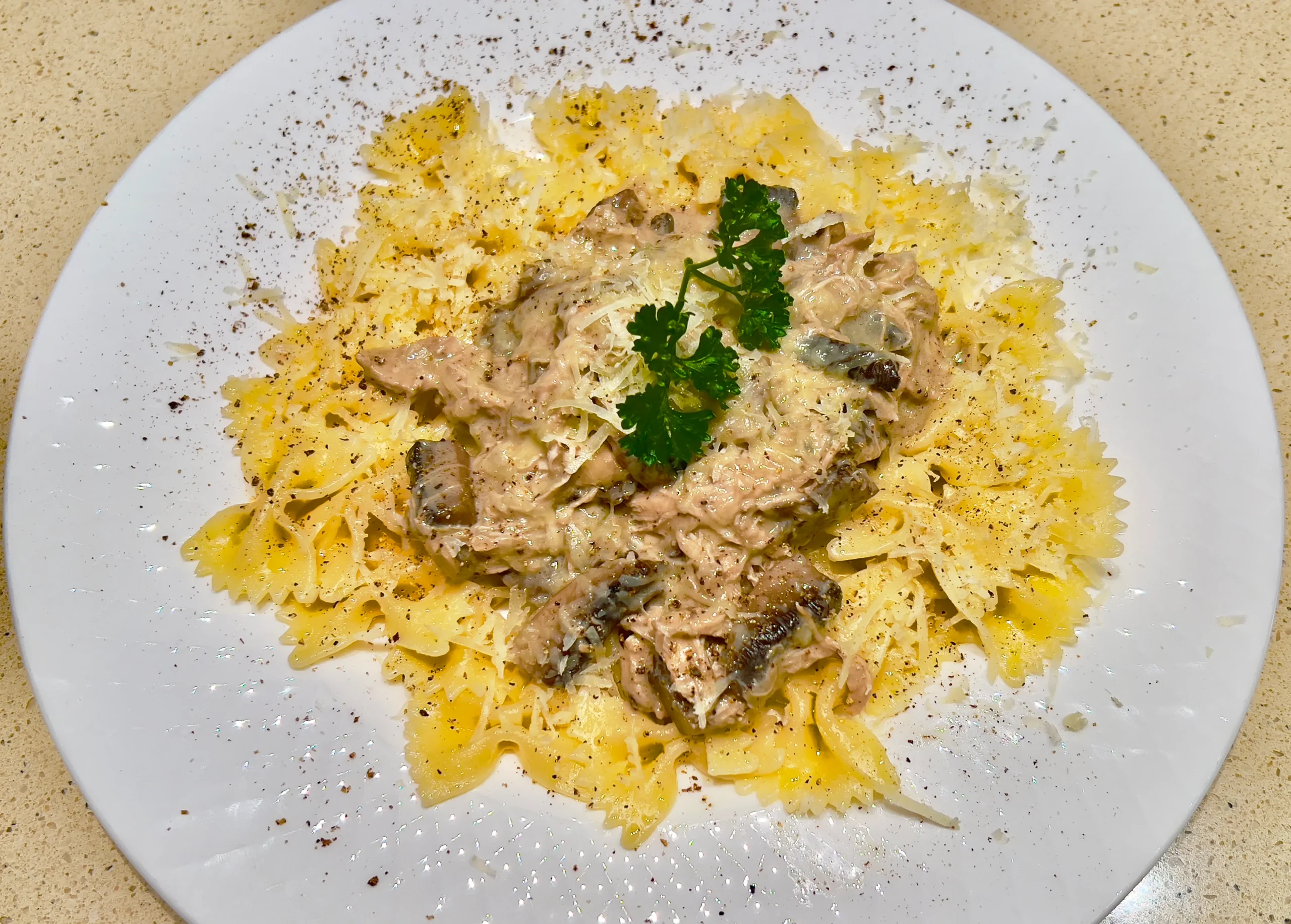 Creamy Marry Me Pasta with chicken and sun-dried tomatoes in a pan.