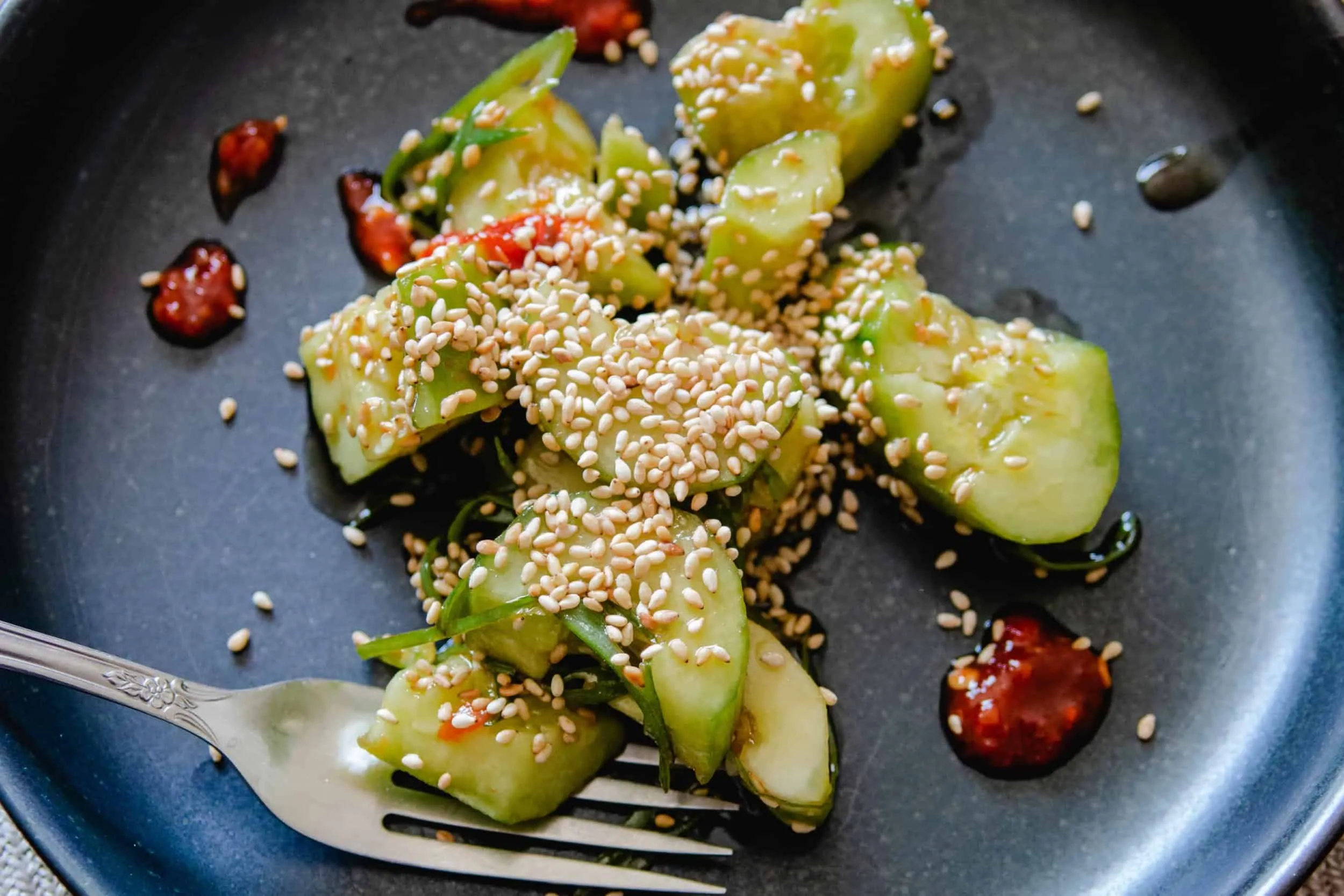 Fresh Thai cucumber salad with herbs and peanuts in a summer bowl.