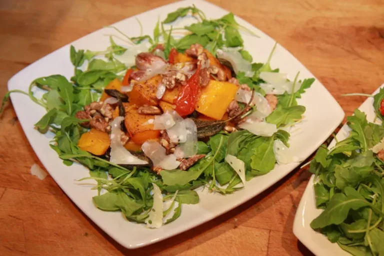 Colorful autumn vegan salad with roasted butternut squash, cranberries, and pumpkin seeds
