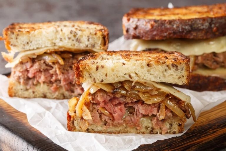 Close-up of a juicy patty melt with crispy bread, gooey cheese, and caramelized onions ready to serve