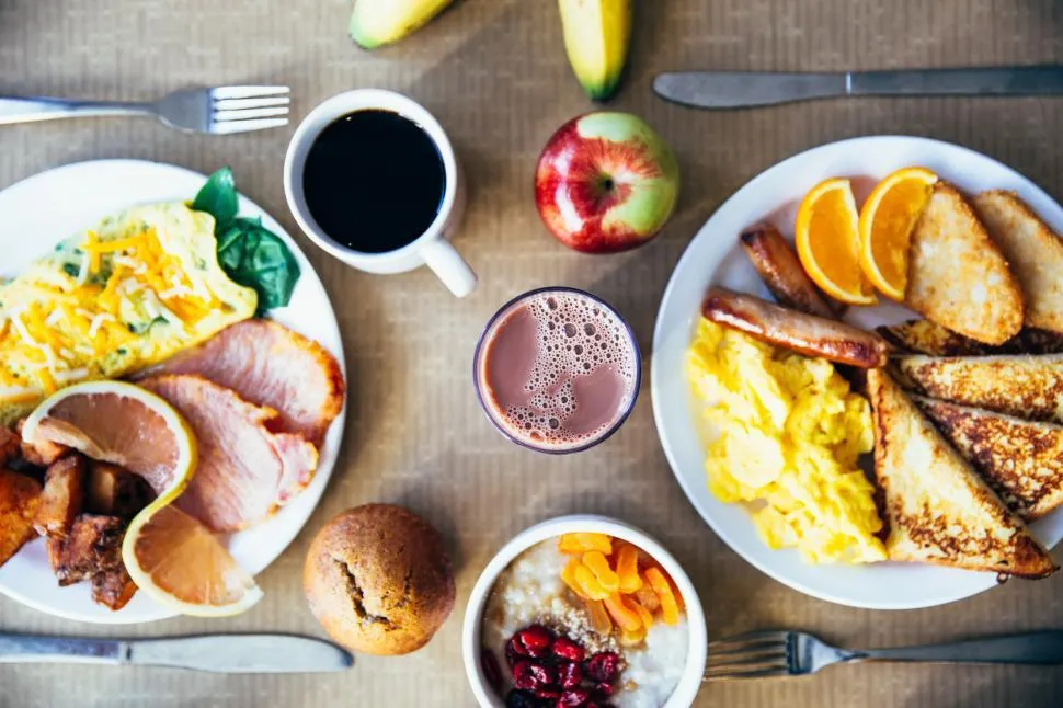 Cozy weekend brunch spread with pancakes, avocado toast, eggs, fruit, and coffee